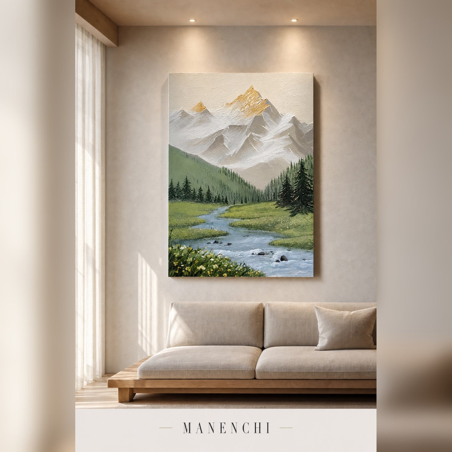 A vertical canvas art print depicting a scenic mountain landscape with a winding river and green forest, displayed on a beige wall above a modern light beige sofa in a styled living room setting.